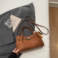 Brown suede tote bag with leather straps and silver twist lock in a lifestyle setting - Standard Type / Brown