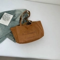 Detailed view of brown suede tote bag with plaid lining and casual lettering print - Brown