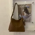 Close-up detail of leopard print faux suede bucket bag with stylish gold zipper pocket - Leopard Print (Brown) / Brown