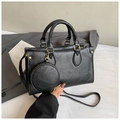Detail of black lychee grain handbag with gold hardware and a round coin purse charm - Black