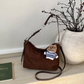 Detail of dark brown suede tote bag featuring a cute plush bear charm and metallic strap accents - Coffee with Pendant