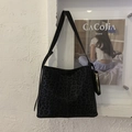 Detail of leopard print suede bucket bag showing textured fabric and small zipper pouch - Leopard (Black) / Black