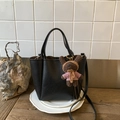 Detail of black lychee grain leather crossbody bag with cute plush bear charm accessory - Black With Pendant