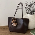 Détail du sac cabas marron foncé avec texture litchi, charm d'ours en peluche et pompon en cuir - Avec Pendentif / Brun