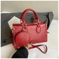 Detail of red vintage leather handbag set with gold hardware and wrinkled texture - Red