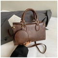 Deep brown vintage leather handbag detail with small round coin purse and gold rivets - Brown