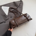 Chic dark brown faux leather cylinder shoulder bag with slim straps on a grey blazer - No Pendant / Brown