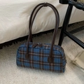 Detailed macro view of blue and brown checkered woolen handbag with leather straps - Blue