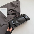 Minimalist black leather underarm pillow bag with glossy finish and cylindrical body - No Pendant / Black