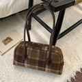 Close-up of vintage brown plaid wool handbag with double zippers on white fur carpet - Brown