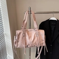 Detailed view of pink Boston bag featuring decorative criss-cross lacing and long tassels - Pink