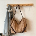 Vintage brown leather tote bag with silver buckle hanging on a wooden rack - Khaki No Pendant