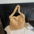 Close-up of a large leopard print plush tote bag in a cozy home lifestyle setting - Yellow Leopard Print