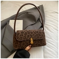 Detail of vintage leopard print suede shoulder bag with golden metallic clasp buckle - Brown