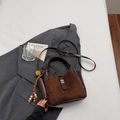 Deep brown retro bucket bag in suede and smooth leather with artistic flower charm - Coffee with Pendant
