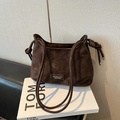 Detail view of the vintage coffee brown suede half-moon shoulder bag with silver hardware - Brown