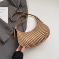 Close-up of vertical pleated texture on a khaki crescent shoulder bag with strap - Khaki