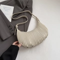 Detail of cream pleated crescent underarm bag on grey blazer for a modern aesthetic - Off White