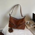 Vintage brown crossbody bag in suede finish with silver hardware on a white desk - Brown