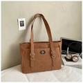 Detail view of brown faux suede tote bag featuring metallic twist lock and chic metal rings - Brown