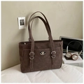 Close-up of brown faux leather tote bag with silver twist lock and buckle details - Brown