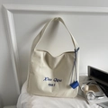 Minimalist cream canvas tote bag with blue embroidery and matching blue pendant accessory - Off-white