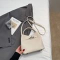 Beige lychee pattern leather bucket bag with silver twist lock and crossbody strap - Off-white Without Pendant