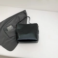 Minimalist black glossy tote bag with gold hardware and shoulder strap for work - Black