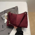 Detail of burgundy suede tote with chain-wrapped gold links and leather crossbody strap - Burgundy