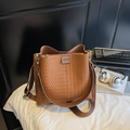 Détail du sac seau marron tressé avec bandoulière large et pochette interne - Grille Marron