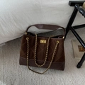 Close-up of brown quilted suede bucket bag with gold chain strap and square metal lock - Coffee Large