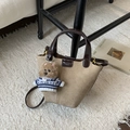 Detail of khaki frosted suede bucket bag with magnetic clasp and cute puppy pendant - Khaki with Pendant