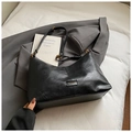 Close-up of black oil wax leather handbag with golden metal plate and adjustable strap - Black without Pendant
