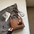 Detail of leopard print handbag with plush monster charm and detachable strap - With Pendant / Brown