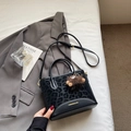 Detail of black leopard print crossbody bag with gold text and plush bear charm - With Pendant / Black
