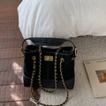 Quilted black bucket bag with gold hardware and chain strap in sleek matte finish - Black Small
