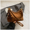 Detail of a brown suede hobo bag featuring a retro wooden bead tassel and gold ring hardware - Brown (With Pendant)