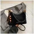 Detail of black suede tote bag with decorative wooden bead tassels on a grey blazer - Black (With Charm)