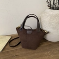 Detail view of coffee suede bucket bag with leather trim and gold metal hardware hooks - Coffee without Pendant