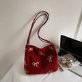 Dettaglio della borsa tote in lana rossa con ricamo a fiocco beige e tracolla sottile - Borgogna