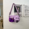 Detail view of purple nylon crossbody bag with side drawstring mesh pocket and yellow cord - Purple