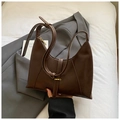 Detail view of dark brown matte faux leather underarm bag with golden needle buckle - Brown