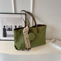 Detail of green suede tote bag with quilted diamond pattern and a small round coin purse - Green