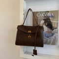 Detail view of deep brown suede tote bag with gold metal twist lock and vintage texture - Coffee Small