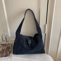 Close-up of matte suede hobo bag with silver buckle strap on a white surface - Twilight Blue