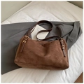 Close-up of brown suede shoulder bag with golden metal buckles on a minimalist white background - Brown