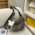 Chic leopard print crossbody bag with plush charm and wide adjustable shoulder strap - Cream Leopard Print with Charm