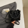 Minimalist black bucket bag with mixed textures, braided handle and golden hardware - Black