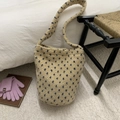 Detail view of plush lamb wool bucket bag with blue polka dots and soft fuzzy texture - Khaki