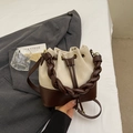 Minimalist cream and coffee color bucket bag with a stylish braided handle and drawstring - Off-white